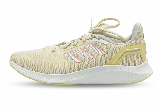 Beige running shoe with white sole on a white background